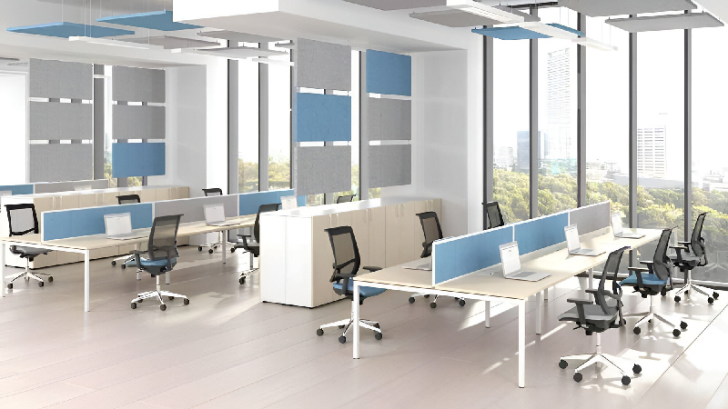 An office with a clear partition, separating the desks and chairs in the room.